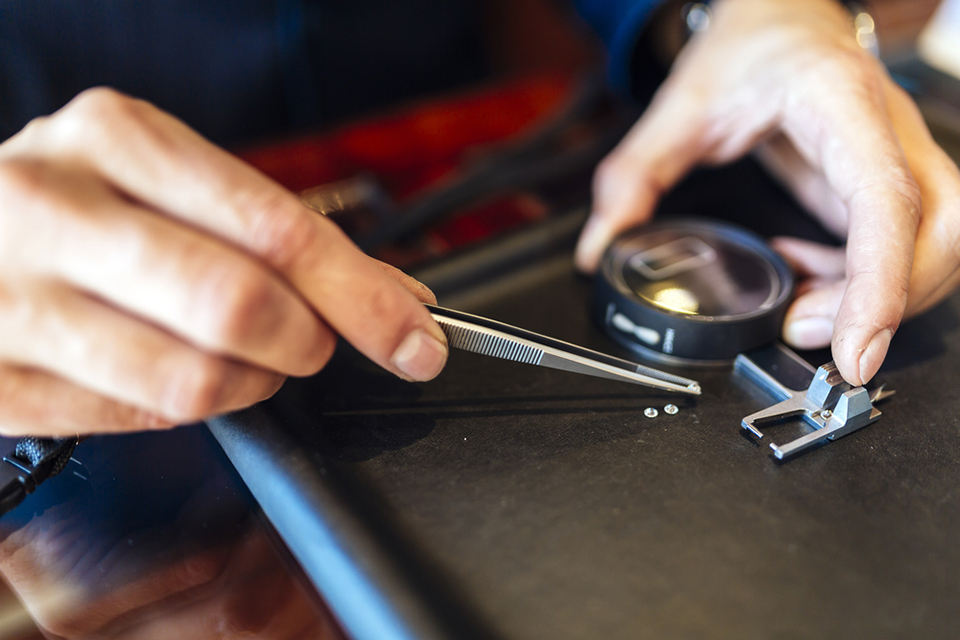 a jeweler checking the size of a diamond