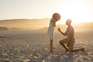man proposing on beach