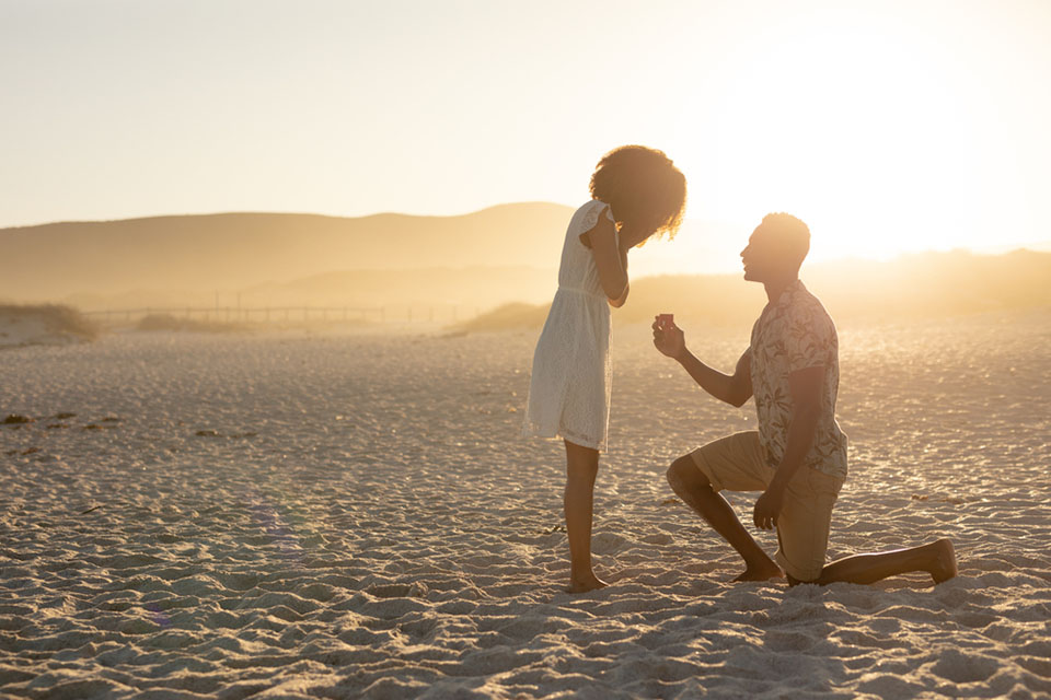 man proposing on beach
