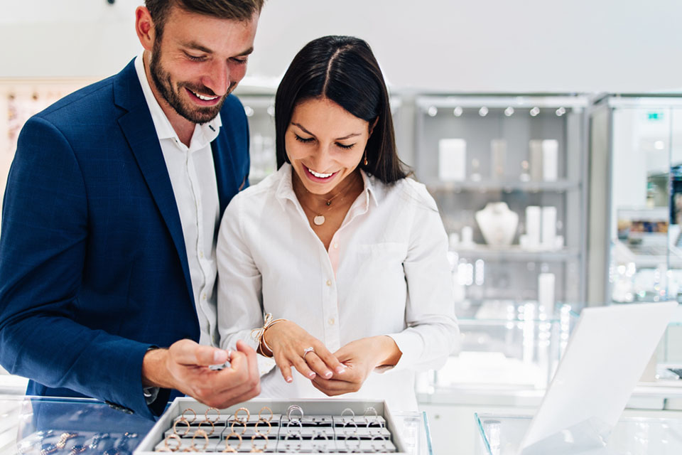 couple in jewelry store browse rings